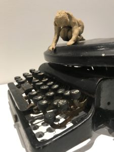 sculpture from old typewriter and small ceramic figure