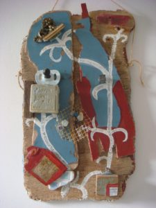 small collection of found objects, soap, bees with driftwood and blue and red paint
