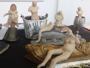 small stoneware figures surreally combined with everyday found objects