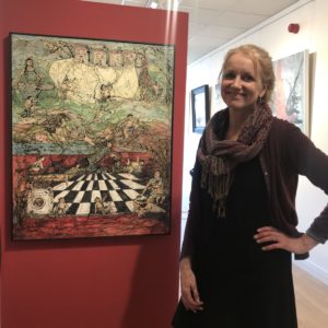 delpha hudson standing by her painting in clifton fine art