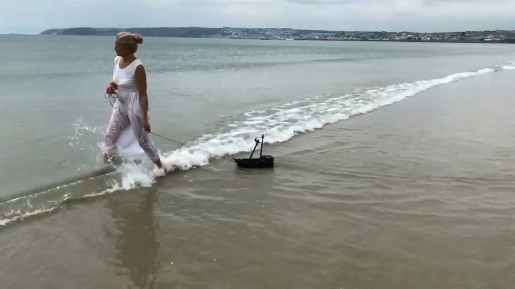 woman pulling a small boat 