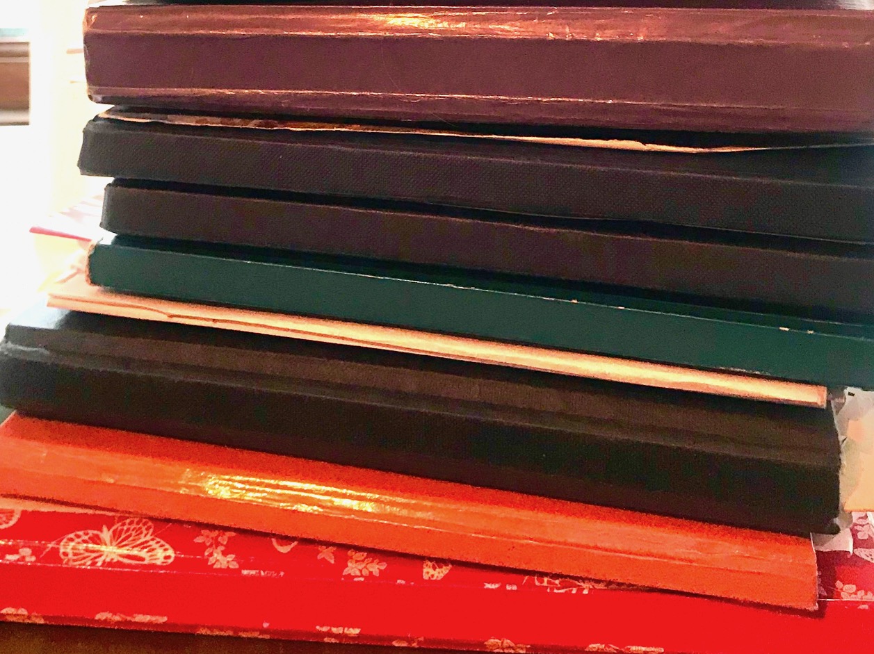 shows a pile of colourful diaries