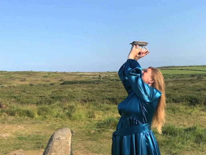 woman in a blue dress ironing the sky