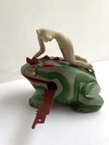sculpture with small found object, paint and scaled stoneware figure