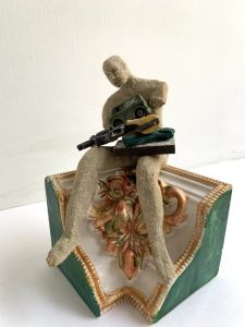 small sculpture found objects and stoneware figure